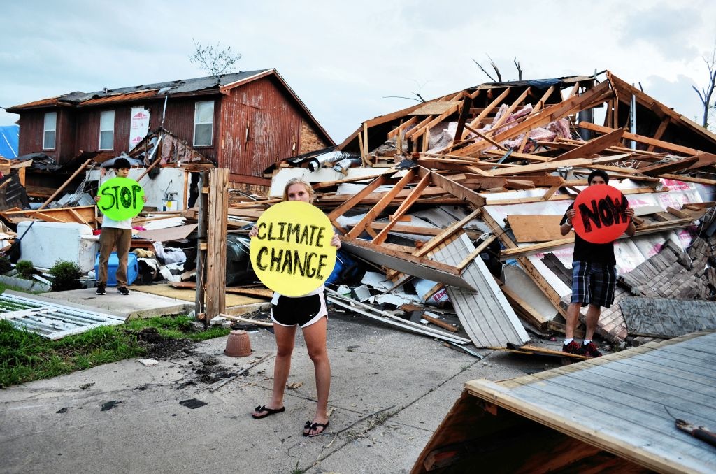 High school students hold dots in Lancaster, Texas where tornadoes wrecked the town. Research shows that climate change may increase conditions that lead to tornadoes. Photo: 350.org