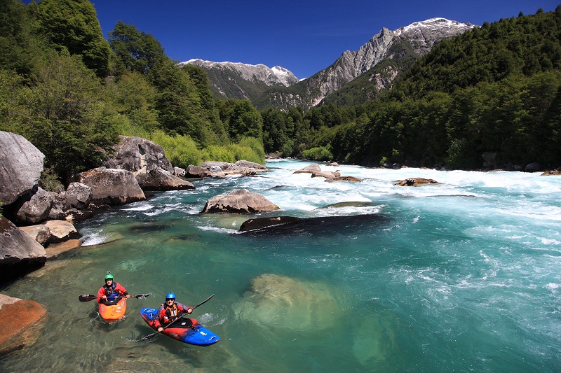 The incredible clarity of Futaleufú is shown here when two kayaks float in the backwater in the middle of Terminator rapid. Photo: Alex Nicks